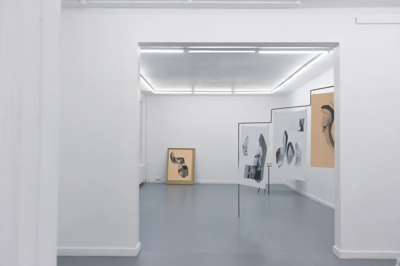 View through a doorway into the gallery with the hanging prints