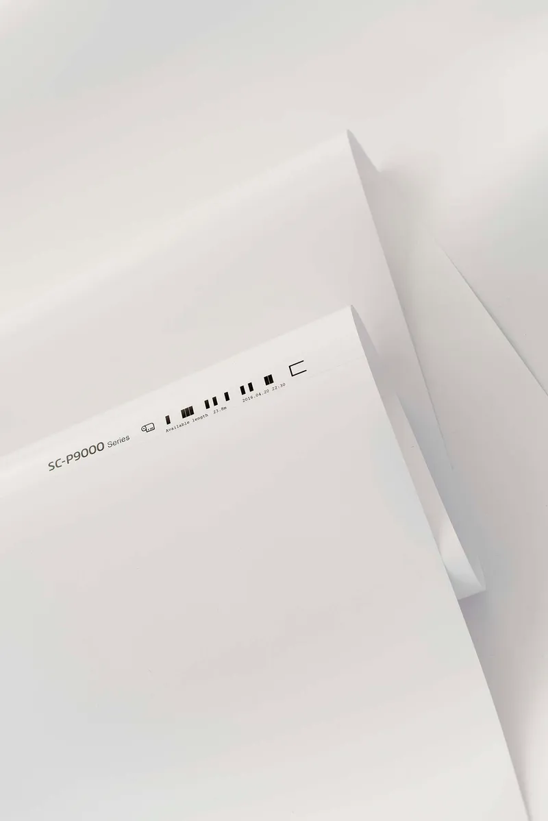Folded white paper with a printed line of marks