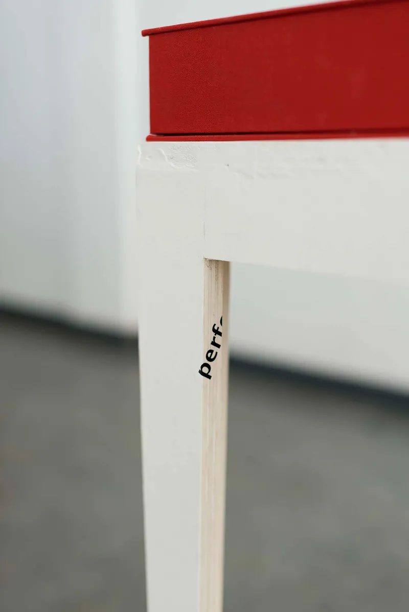 Close-up of the red box on the white plinth