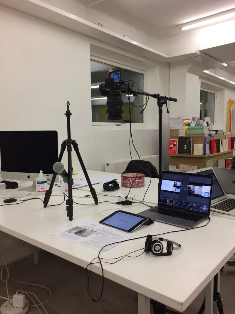 The streaming set-up in the Index bookshop: camera on a boom stand, microphone on a tripod, laptops and an iPad on a white table