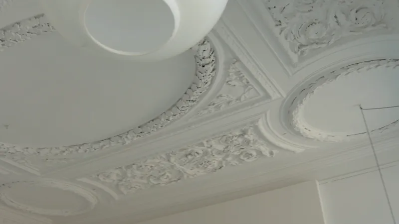 A stucco ceiling with a round lamp